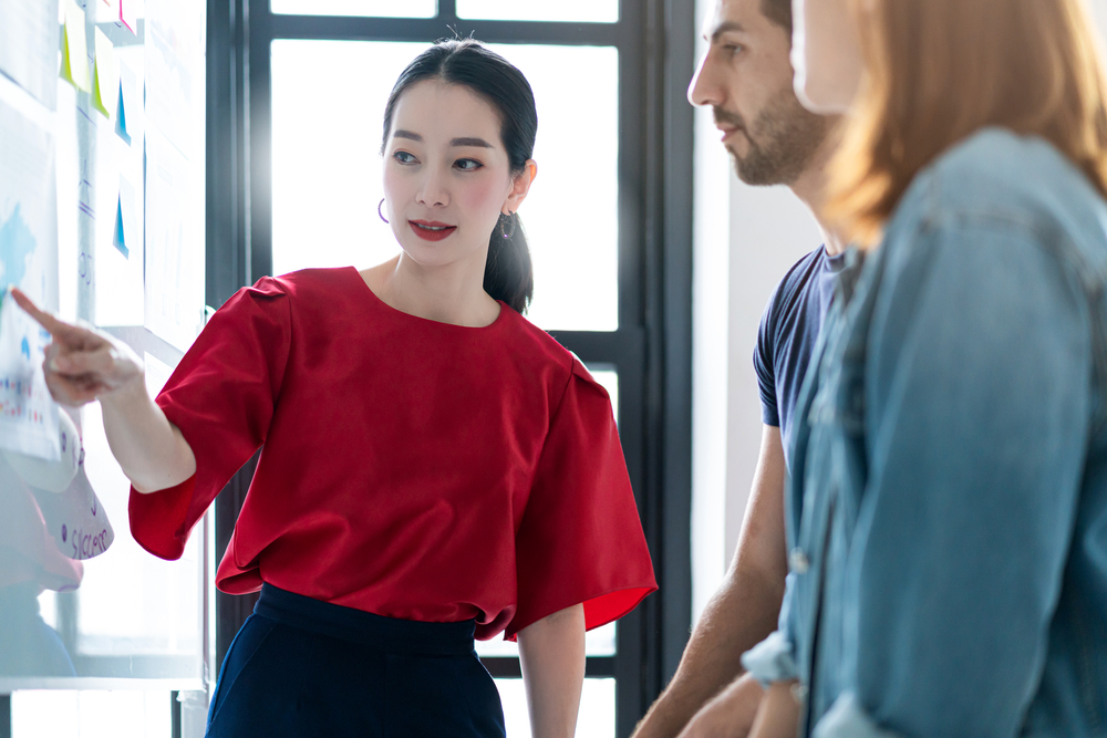 Foreign employee presenting ideas to colleagues during a business meeting in Japan